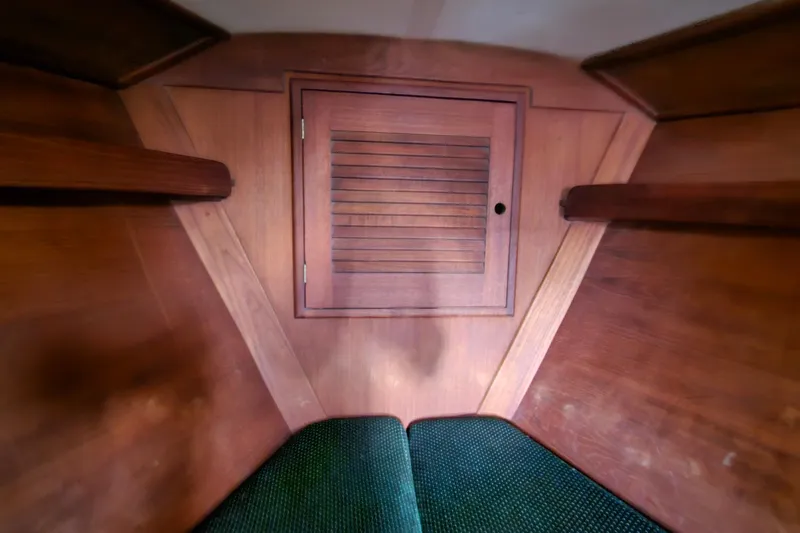 Slide: The Image of Interior of 1987 Tartan 37 sailboat with wooden cabinetry and green upholstery. - 67