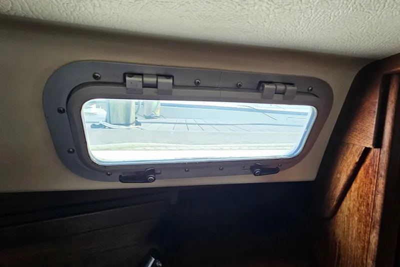 Slide: The Image of Interior view of a 1987 Tartan 37 sailboat porthole with dockside scenery. - 70