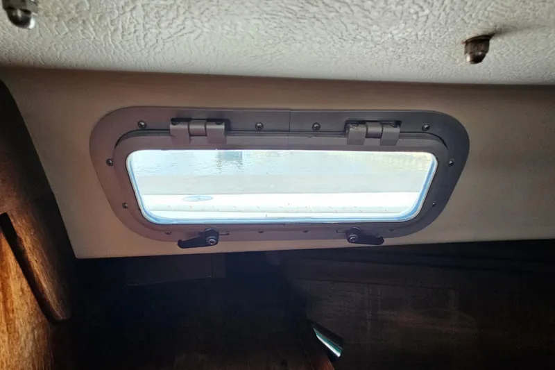 Slide: The Image of Interior view of a 1987 Tartan 37 sailboat porthole with secure latches. - 71