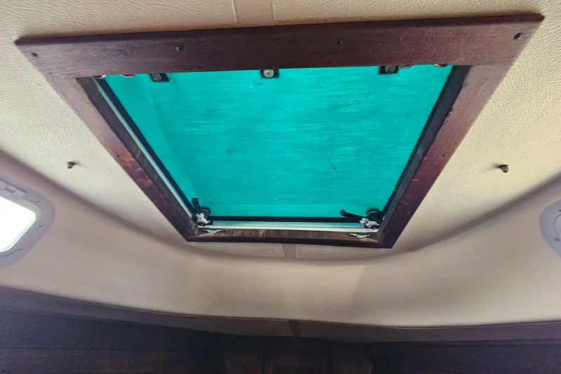 Slide: The Image of Interior view of a 1987 Tartan 37 sailboat hatch with teal cover. - 72