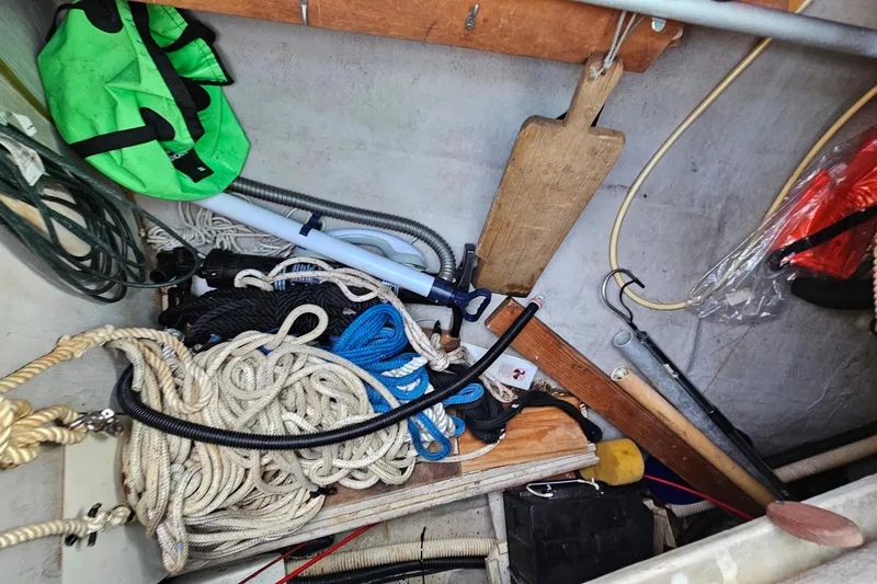 Slide: The Image of Storage compartment on a 1987 Tartan 37 sailboat with ropes and equipment. - 74
