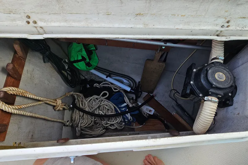 Slide: The Image of Storage compartment of a 1987 Tartan 37 sailboat with ropes and equipment. - 75