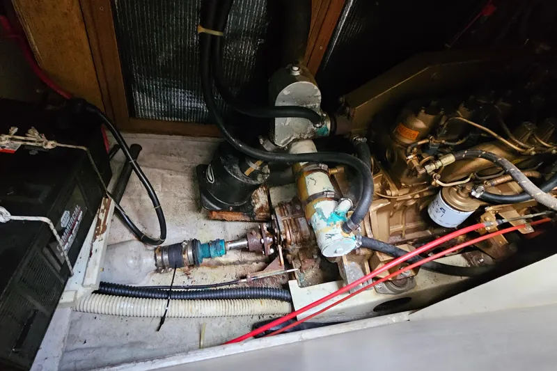 Slide: The Image of Engine compartment of a 1987 Tartan 37 sailboat, showing mechanical components and wiring. - 77