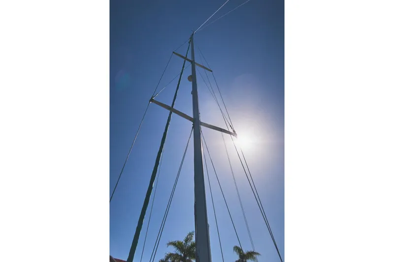 Slide: The Image of Mast of 1987 Tartan 37 sailboat against clear blue sky and bright sun. - 78