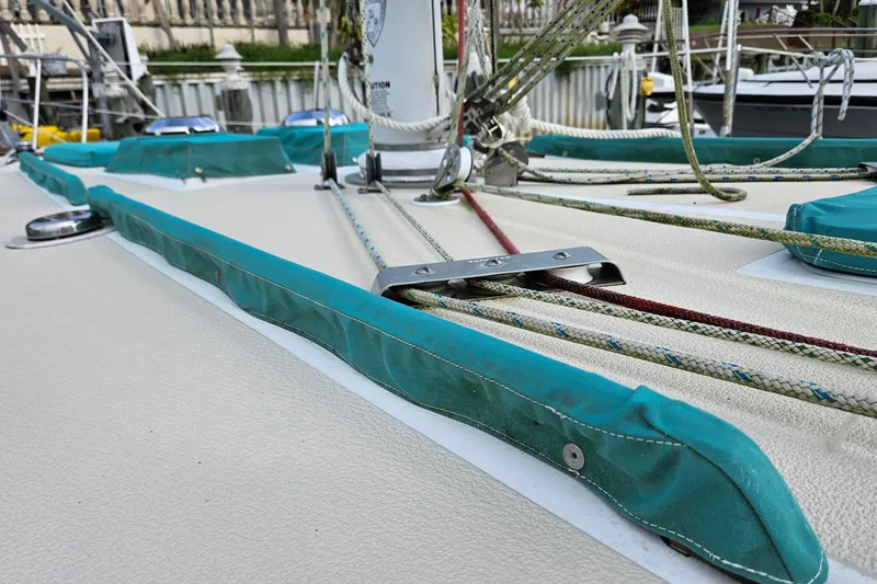 Slide: The Image of 1987 Tartan 37 sailboat deck with teal covers and rigging details. - 8