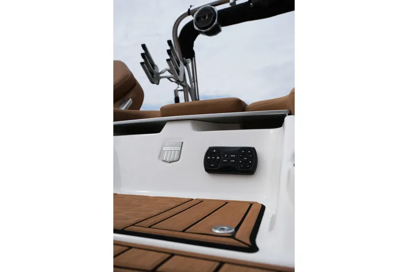 Slide: The Image of 2019 MasterCraft X22 boat interior with control panel and teak flooring. - 10