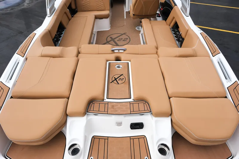 Slide: The Image of 2019 MasterCraft X22 boat interior with tan seating and sleek design. - 15