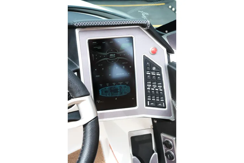 Slide: The Image of Dashboard of 2019 MasterCraft X22 boat with touchscreen controls and steering wheel. - 16