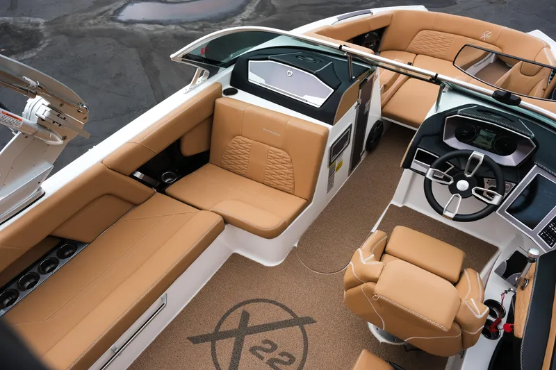 Slide: The Image of 2019 MasterCraft X22 boat interior with tan leather seats and modern dashboard. - 22