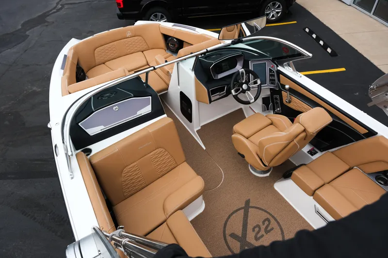 Slide: The Image of 2019 MasterCraft X22 boat interior with tan seating and modern dashboard design. - 23
