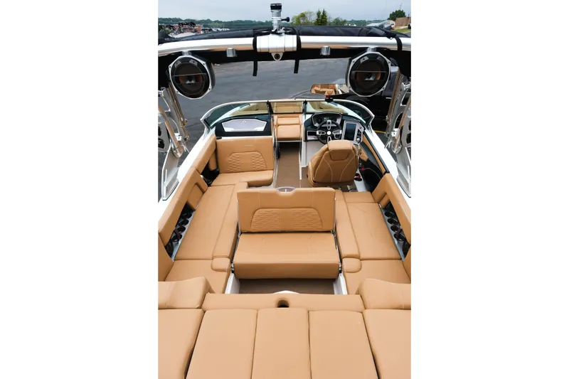 Slide: The Image of 2019 MasterCraft X22 boat interior with tan seating and modern dashboard. - 24