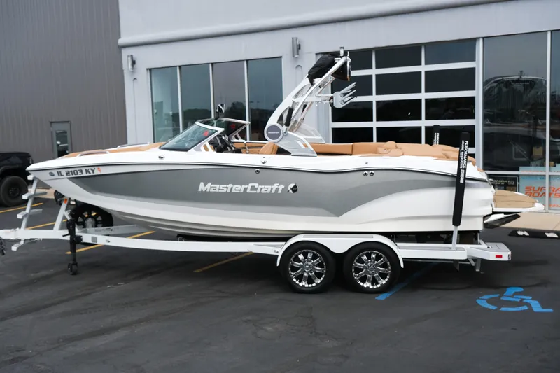 Slide: The Image of 2019 MasterCraft X22 boat on trailer, parked outside a building. - 3