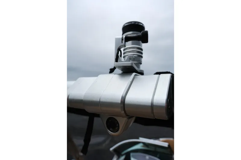 Slide: The Image of Close-up of a 2019 MasterCraft X22 boat component against a cloudy sky. - 32