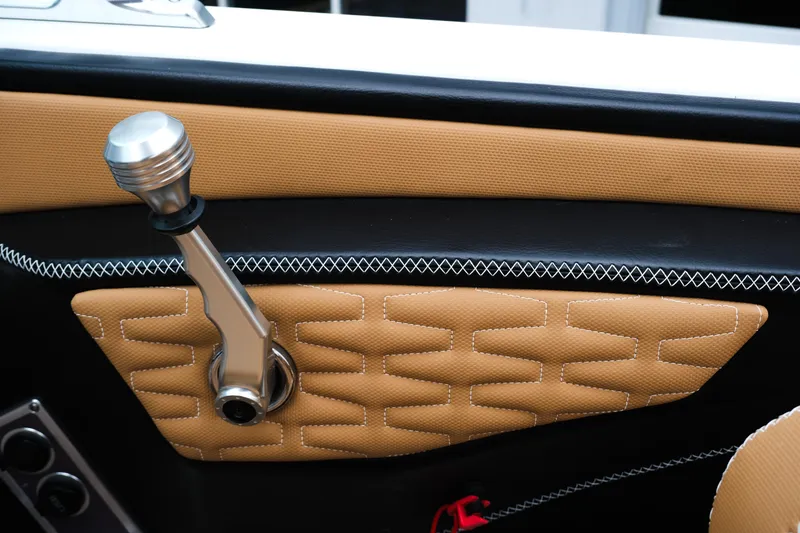 Slide: The Image of 2019 MasterCraft X22 interior detail with tan upholstery and metallic control lever. - 33