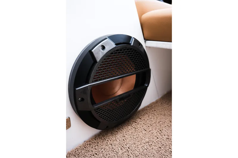 Slide: The Image of Speaker detail in 2019 MasterCraft X22 boat interior, featuring black grille and beige seating. - 34