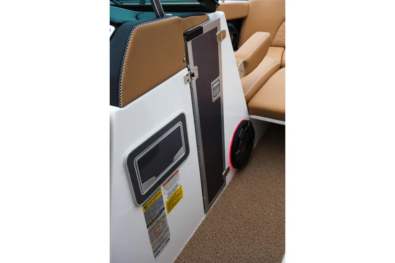 Slide: The Image of 2019 MasterCraft X22 interior detail with tan seating and storage compartment. - 38