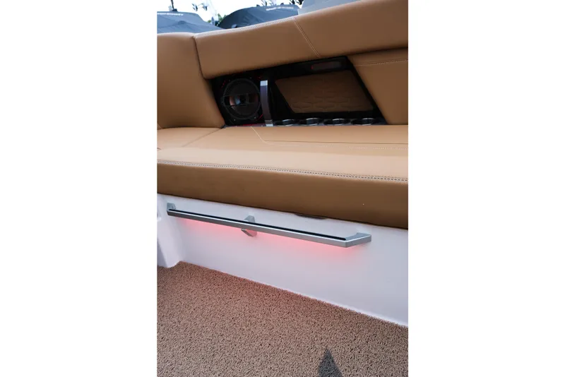 Slide: The Image of 2019 MasterCraft X22 boat interior with tan seating and ambient lighting. - 39
