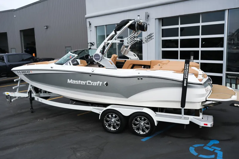 Slide: The Image of 2019 MasterCraft X22 boat on trailer, parked outside a building. - 4