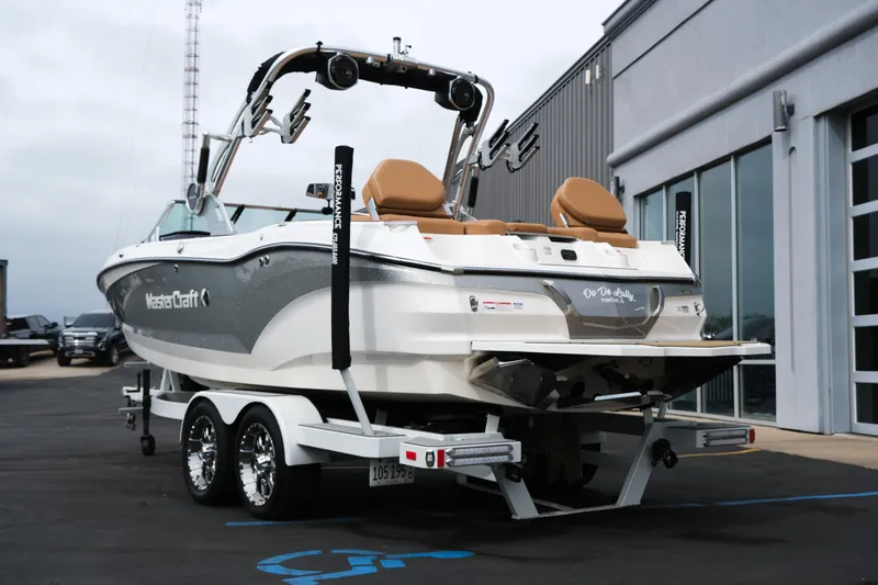 Slide: The Image of 2019 MasterCraft X22 boat on trailer, parked outside a building. - 6