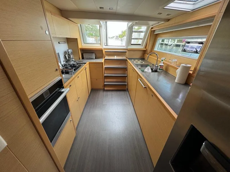 Slide: The Image of Modern kitchen interior on 2015 Lagoon Motor Yacht, featuring sleek cabinetry and appliances. - 23