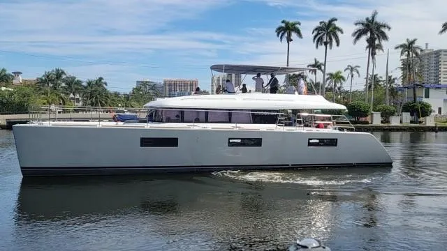 Slide: The Image of 2015 Lagoon Motor Yacht cruising on a tropical waterway with palm trees in the background. - 35