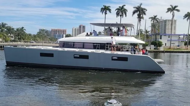 Slide: The Image of 2015 Lagoon Motor Yacht cruising on a sunny day with palm trees in the background. - 37
