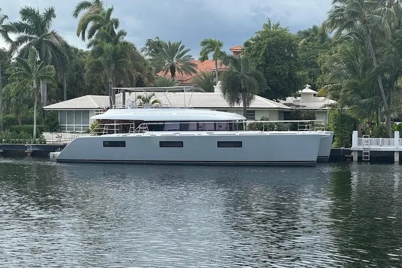 Slide: The Image of 2015 Lagoon Motor Yacht docked by a waterfront home with palm trees. - 8