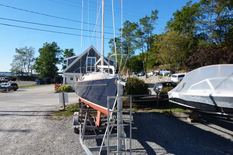 Slide: The Image of Alerion Express 28 sailboat, 2006 model, on trailer in a marina setting. - 14