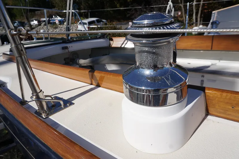 Slide: The Image of 2006 Alerion Express 28 sailboat deck with polished winch and wooden trim. - 27