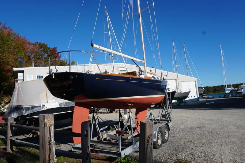 Slide: The Image of Alerion Express 28 sailboat from 2006 on a trailer in a boatyard. - 9