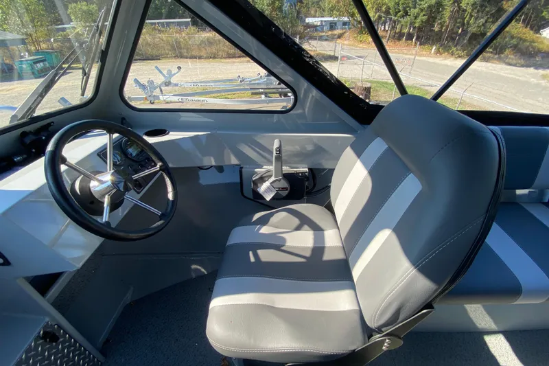 Slide: The Image of Interior of 2026 Hewescraft 180 Sportsman boat with steering wheel and seating. - 11
