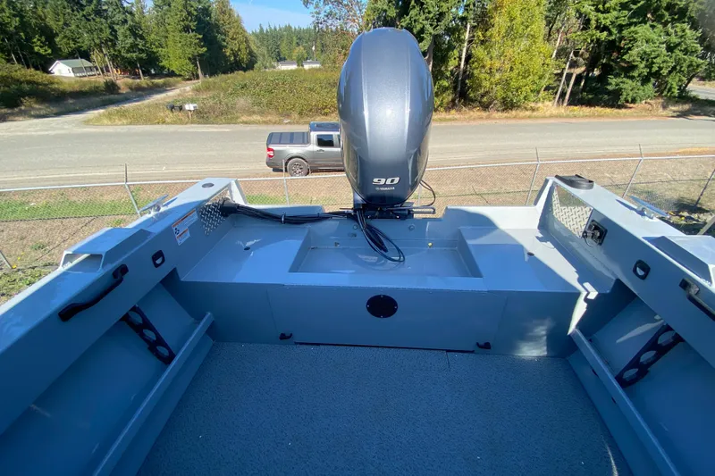 Slide: The Image of 2026 Hewescraft 180 Sportsman boat with Yamaha 90 engine, parked outdoors. - 12