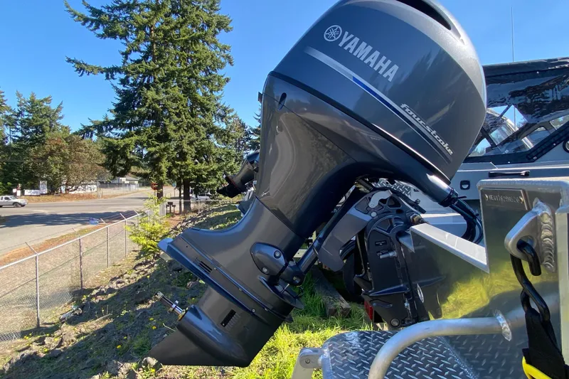 Slide: The Image of 2026 Hewescraft 180 Sportsman with Yamaha outboard motor in outdoor setting. - 13