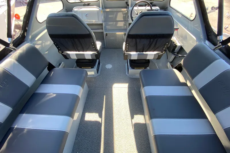 Slide: The Image of Interior of 2026 Hewescraft 180 Sportsman boat with gray seating and steering console. - 6