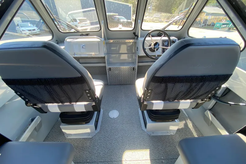 Slide: The Image of 2026 Hewescraft 180 Sportsman boat interior with dual seats and steering wheel. - 7