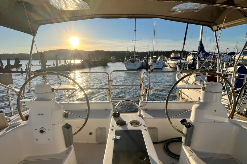 Slide: The Image of Cockpit view of 1996 Catalina 400 sailboat at sunset in marina. - 11