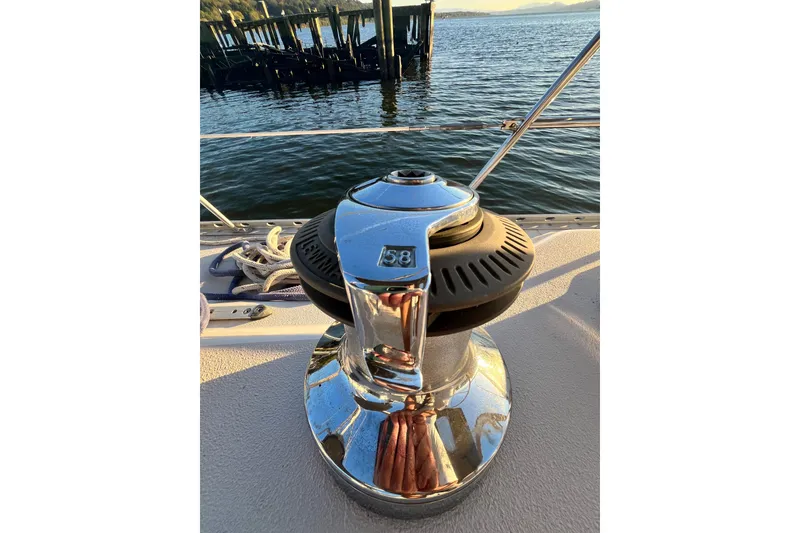 Slide: The Image of Winch on 1996 Catalina 400 sailboat deck, overlooking calm water and pier. - 12