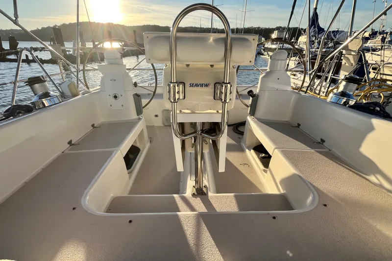Slide: The Image of Cockpit of 1996 Catalina 400 sailboat at sunset, featuring steering wheel and seating. - 13