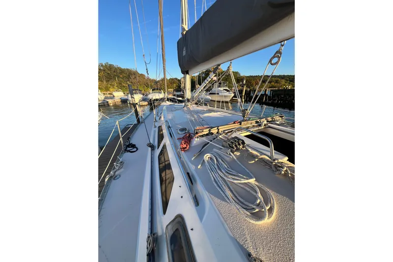 Slide: The Image of Sailboat deck view of 1996 Catalina 400, docked in a marina under clear skies. - 16