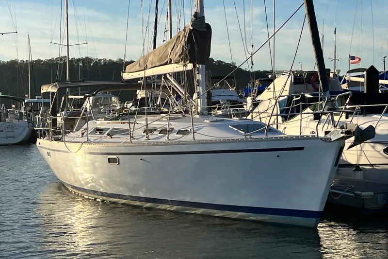 Slide: The Image of 1996 Catalina 400 sailboat docked in a marina at sunset. - 2