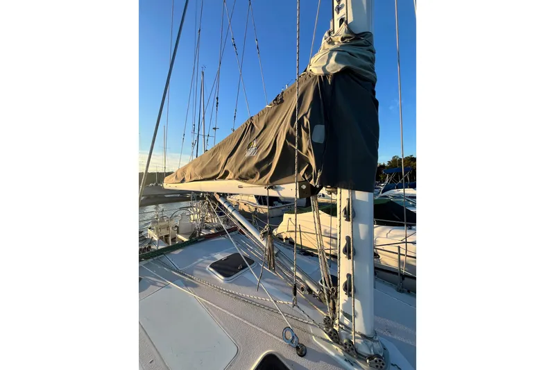 Slide: The Image of Sailboat deck view of a 1996 Catalina 400 with covered mainsail at sunset. - 24