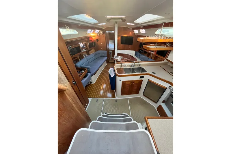 Slide: The Image of Interior of 1996 Catalina 400 yacht with modern kitchen and cozy seating area. - 29