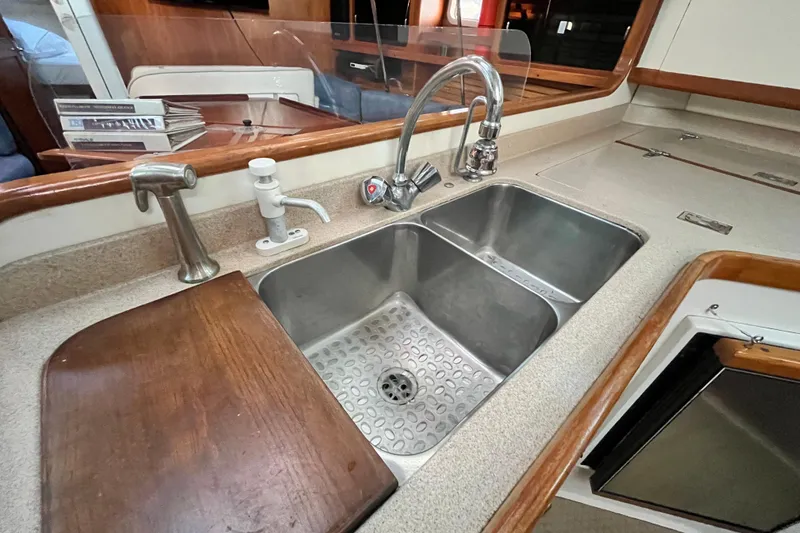 Slide: The Image of Double sink in 1996 Catalina 400 yacht kitchen with wooden accents and modern fixtures. - 34