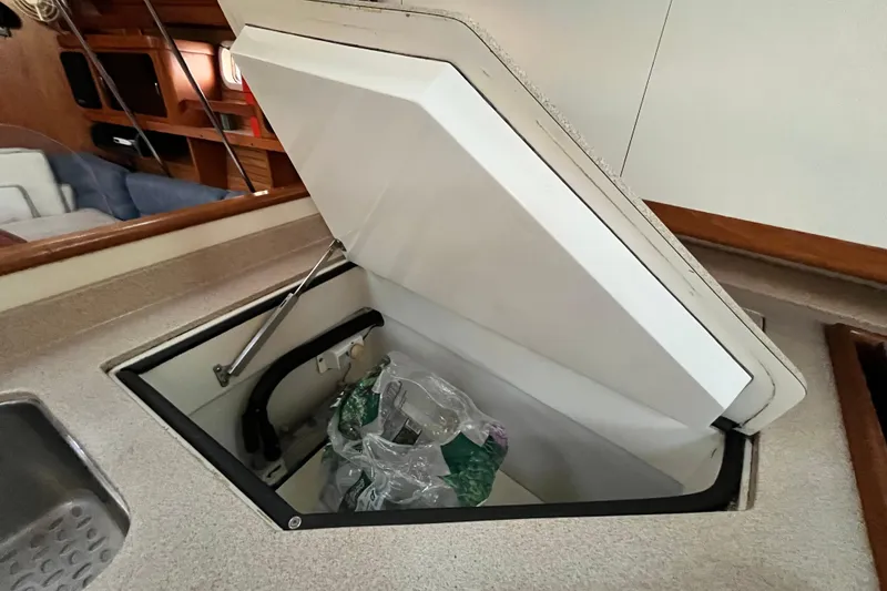 Slide: The Image of Open storage compartment in 1996 Catalina 400 yacht interior. - 35