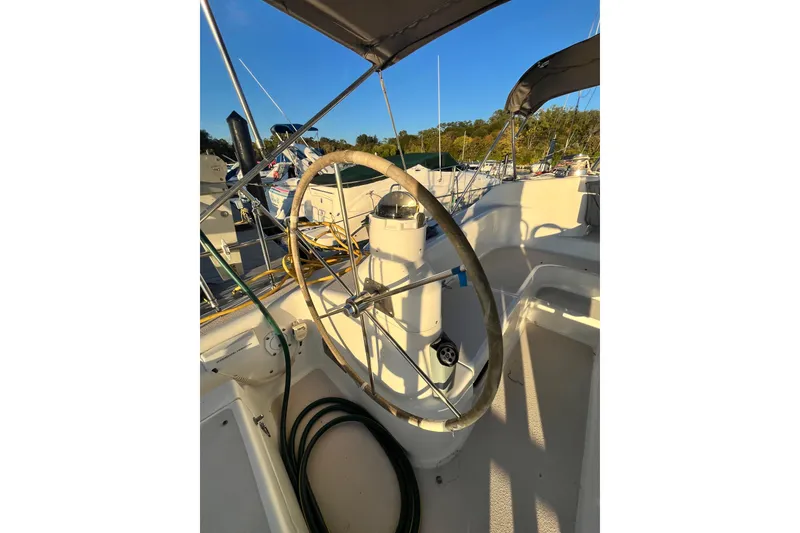 Slide: The Image of Steering wheel of a 1996 Catalina 400 sailboat in a marina setting. - 4