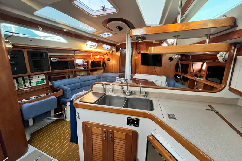 Slide: The Image of Interior of a 1996 Catalina 400 yacht with modern kitchen and cozy seating area. - 42