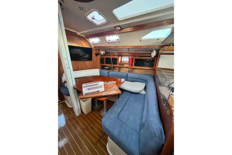 Slide: The Image of Interior of 1996 Catalina 400 yacht with blue seating and wooden accents. - 45
