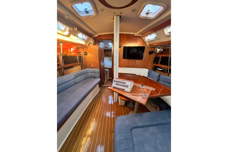 Slide: The Image of Interior of a 1996 Catalina 400 sailboat with cozy seating and wooden finishes. - 46