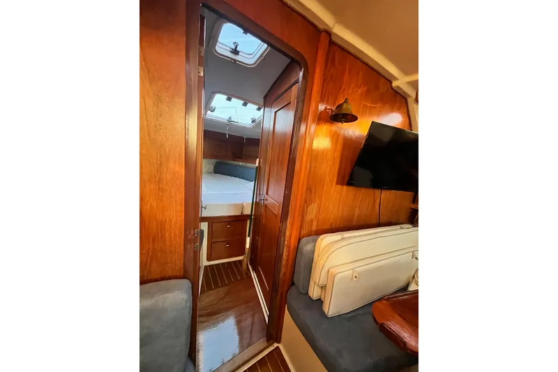 Slide: The Image of Interior of a 1996 Catalina 400 sailboat, featuring wood paneling and a cozy cabin. - 47
