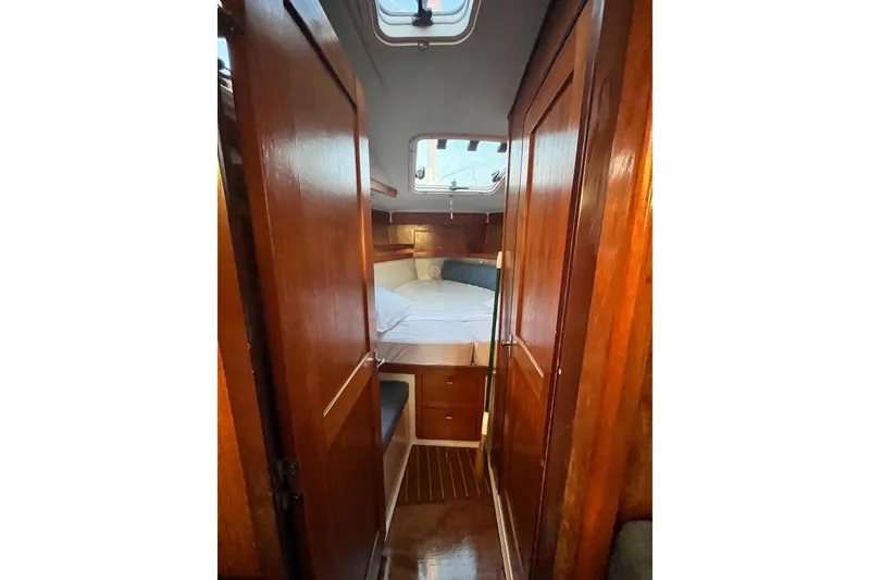 Slide: The Image of Interior of 1996 Catalina 400 sailboat with wooden cabinetry and cozy sleeping area. - 48